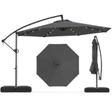 Black patio umbrella with stand on a white background