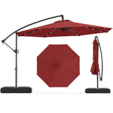 Red patio umbrella with stand on a white background