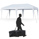 Man carrying a folded black gazebo against a white background