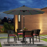 Outdoor patio set with a large black umbrella, table, and chairs on a patio with city skyline in the background.