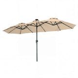 Beige patio umbrella with black frame on a white background