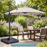 Outdoor patio set with table, chairs, and cantilever umbrella in a garden setting.