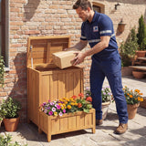 Man in blue work uniform opening a wooden garden storage box filled with flowers.