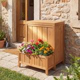 Wooden planter box with flowers against a stone wall