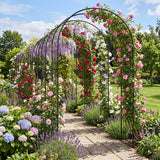Floral archway in a garden with various flowers and a clear sky.