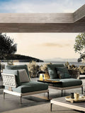Modern outdoor furniture set with a scenic view of trees and mountains.