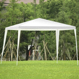 White outdoor canopy tent set up on grass with trees in the background