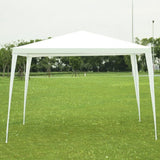 White outdoor canopy tent set up on a grassy field with trees in the background