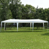 White outdoor canopy tent set up on a grassy area with trees in the background