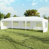 White outdoor canopy tent on grass with trees in the background