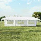 White party tent with side panels on a grassy field under a clear blue sky.