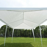 White outdoor canopy tent set up on a grassy area with trees in the background