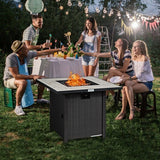 Group of people enjoying a fire pit in a backyard setting with string lights and a table.