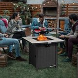 People gathered around a 30 Inch Square Propane Gas Fire Pit Table Ceramic Tabletop in an outdoor setting with a guitar player.