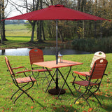 Outdoor furniture set with a red umbrella, table, and chairs in a park-like setting.