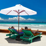Two people relaxing on green lounge chairs under a large white umbrella on a beach.
