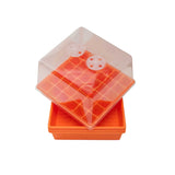 Orange and clear plastic seedling tray with transparent lid on a white background