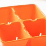 Close-up of an orange plastic 4 Cell Plug Tray Insert