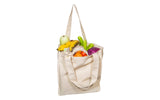 Beige tote bag filled with groceries on a white background