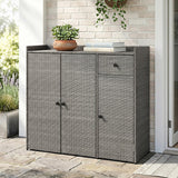 A gray wicker-patterned outdoor storage cabinet with two doors and a top drawer, shown on a patio against a light brick wall with decorative plants and books on top.