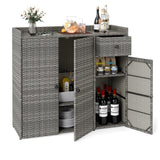Gray wicker-style outdoor bar cart with two doors open, showing shelves and storage compartments. The cart is styled with bottles, glasses, a pitcher, and plates on top and inside, photographed on a clean white background.