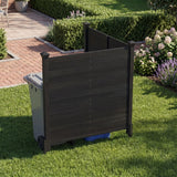 Black outdoor privacy screen with trash can and blue bin against a garden background