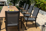 Outdoor dining setup with a table and chairs on a wooden deck.
