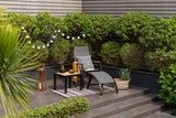 Outdoor seating area with a chair, table, and decorative elements on a patio.