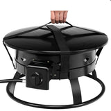 Black portable gas grill with a hand holding onto a handle on a white background