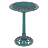 Green metal bird bath with decorative base on a white background