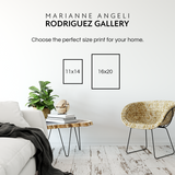 Living room with a couch, coffee table, and chair, featuring Marianne Angeli Rodriguez Gallery text.