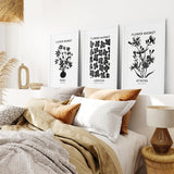 Bedroom with Flower Market Black and White Art Set Decor on the wall, pillows, and a lamp.