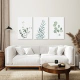 Modern living room with a white sofa, wooden coffee table, and Watercolor Botanical Set of 3 Prints Wall Decor