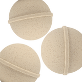Three beige bath bombs on a white background