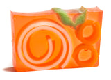 Orange and pink soap bar with circular design on a white background