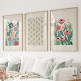 Botanical Pink Poppies Wall Art Poster Decor on a wall above a sofa.