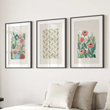Three framed Botanical Pink Poppies Wall Art Poster Decor on a wall above a sofa.