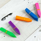 Colorful markers on a white wooden surface