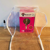 Fungi Friends mushroom growing kit on a clear stand with a wooden surface and white wall background