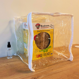 Fungi Friends mushroom growing kit on a wooden surface with a clear plastic bag.