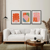 Living room with a white sofa, wooden coffee table, and Henri Matisse Flower Market Colorful Poster on the wall.