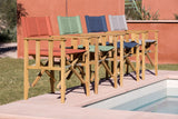 Outdoor wooden dining set with colorful cushions by a poolside.