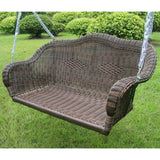 Brown Resin Wicker Porch Swing with 4-ft Hanging Chain on a grassy area with green bushes in the background
