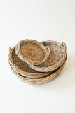 Stack of woven baskets on a white background