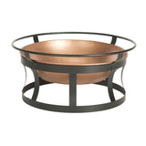 Copper fire pit with black metal stand on a white background