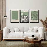 Modern living room with a white sofa, coffee table, and framed Sage Green Exhibition Art Set of 3 Prints. Bauhaus, Kusama, Matisse