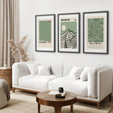 Living room with a white sofa, wooden coffee table, and framed Sage Green Exhibition Art Set of 3 Prints. Bauhaus, Kusama, Matisse