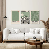 Modern living room with a white sofa, wooden coffee table, andSage Green Exhibition Art Set of 3 Prints. Bauhaus, Kusama, Matisse on the wall.