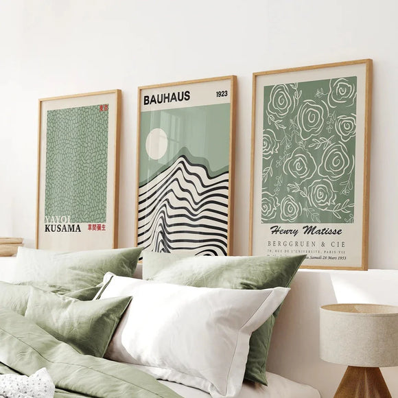 Sage Green Exhibition Art Set of 3 Prints. Bauhaus, Kusama, Matisse on a wall above a bed with green and white bedding.