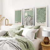 Bedroom with green bedding and framed Sage Green Exhibition Art Set of 3 Prints. Bauhaus, Kusama, Matisse